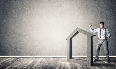 Stone home silhouette in empty room as symbol for real estate insurance