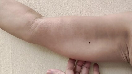 portrait showing the flabbiness adipose hanging skin under the arm, problem wrinkles and flabby skin, armpit hair underarm of the woman, health care and beauty concept.