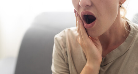 Beautiful blond woman having toothache.