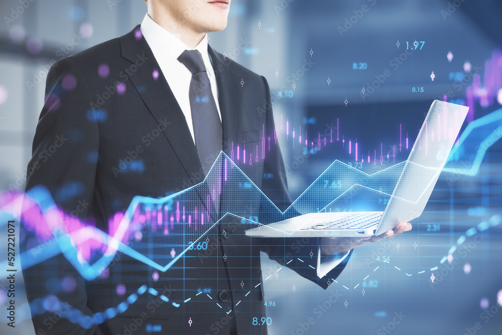 Poster businessman hand holding laptop with abstract glowing candlestick forex chart with index and grid on