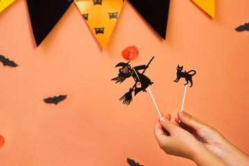 Halloween Theatre of shadows. Paper dolls cat, witch. Child craft, party indoor activity