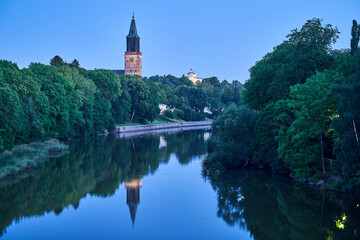 Fototapeta na wymiar Church reflecting in river in the evening