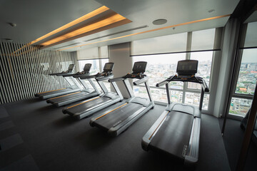 An indoor wellness fitness club with dumbbells and a treadmill to use for your workouts.