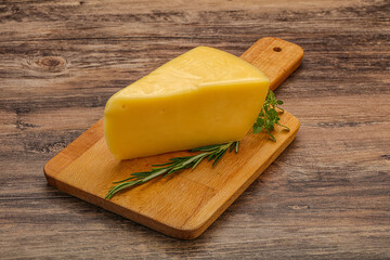 Hard cheese piece served rosemary