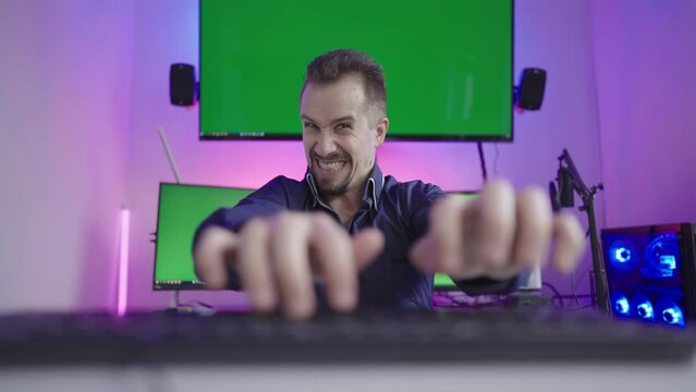 Online troll rage trashing on keyboard with green screens in background 4K