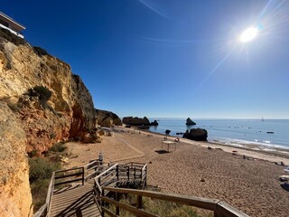 Naklejka premium Praia Dona Ana beach with turquoise sea water and cliffs, Portugal. Beautiful Dona Ana Beach (Praia Dona Ana) in Lagos, Algarve, Portugal Sunrise