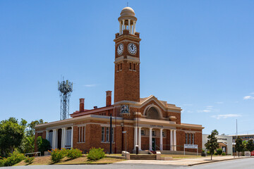 An historic courthouse with a tall clock tower and cupola