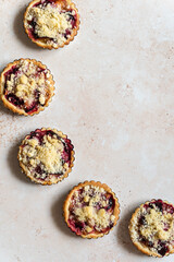 Five home baked plum crumble tarts from above