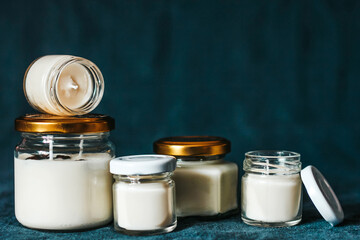 Scented candles in the interior. Candles in a jar on a blue background