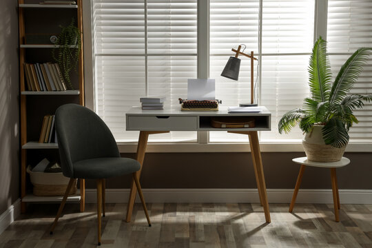 Comfortable Writer's Workplace Interior With Typewriter On Desk In Front Of Window