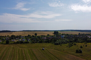 Fototapeta na wymiar Aerial view of agro rural fields. Harvesting on the farm landscape