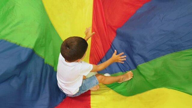 Happy toddlers having an active sensory play with texture and colors at the nursery school. Kids wellness. Early fine motor and gross motor skills development. Healthy brain. High quality 4k footage