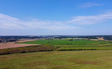 Aerial view of agro rural fields. Harvesting on the farm landscape