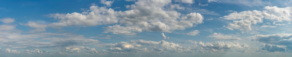 Fantastic clouds against blue sky, panorama