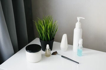 Cosmetics in glass bottles on the boudoir table. Beauty blogger, salon therapy, brand layout, minimalism concept.