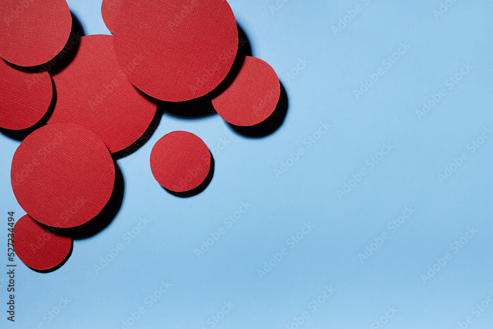 Poster different red textured circles soar as swarm shape on blue background, decorative border with copy s