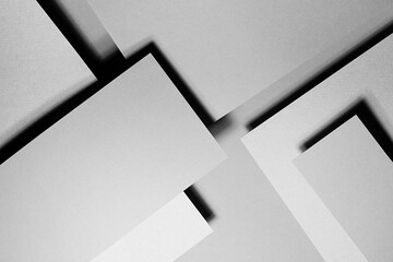 Grey abstract textured geometric relievo stepped background with fly rectangle paper sheets and stripe with corner, lines in hard light, black shadows in luxury business style for design, top view.