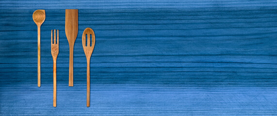 Topview of Set Cooking Wooden Utensils on Blue Table Background