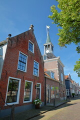 The historical Weigh House (Waag) in the historical center of Makkum, Friesland, Netherlands, with historical houses