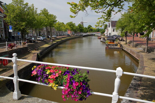 The little canal (klein Diep) viewed from De Zijl bridge in Dokkum, Friesland, Netherlands, with the windmill Zeldenrust in the background