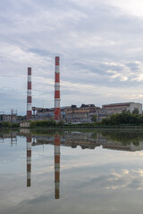 Obraz premium old factory stands near the lake