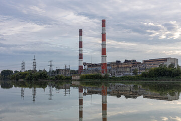 Obraz premium old factory stands near the lake