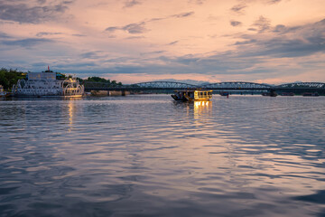 Tourists enjoy the scenery and listen to music on dragon boats to the Perfume River (Song Huong) near Thien Mu pagoda, Hue city, Vietnam