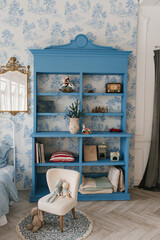 Blue wooden wardrobe in a cozy living room decorated for Christmas