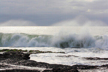 breaking wave on the rocky coastline