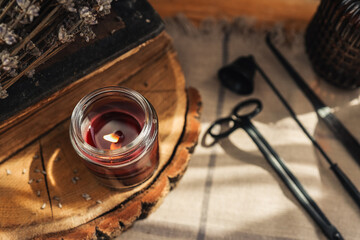 Fototapeta na wymiar Burning candles and accessories for them, atmospheric photo