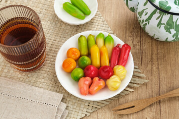 Ang Kue (Kue Ku) or Kanom Look Choup, fruit shaped mung beans. Sticky, chewy texture. 
