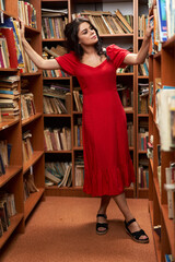 Woman in red dress in a library