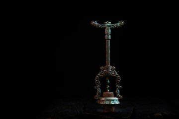 Vintage metal corkscrew with a wine stopper on a dark background.Copy space.Concept of food and...