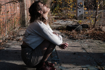 Young curly hair woman portrait in an urban setting in autumn