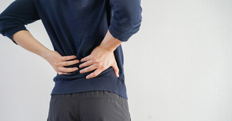 close up athlete man stretching back after workout on white background for spine symptom and...