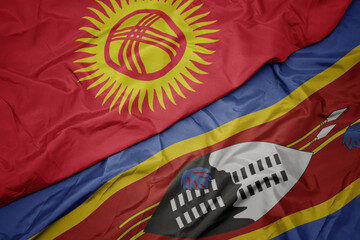 waving colorful flag of swaziland and national flag of kyrgyzstan.