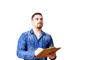 Young man is writing something down on a clipboard.