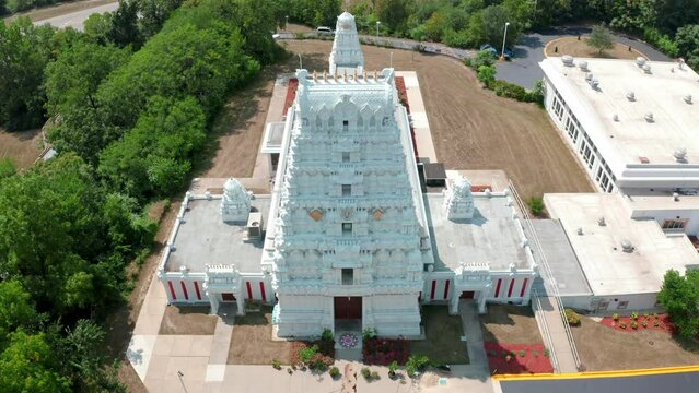 Aerial drone tilt down shot over a a traditional south Indian hindu temple on a sunny day.