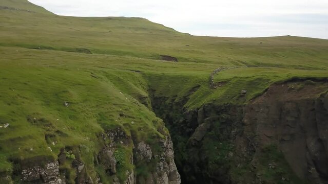Green cliffs of Faroe islands in cloudy weather