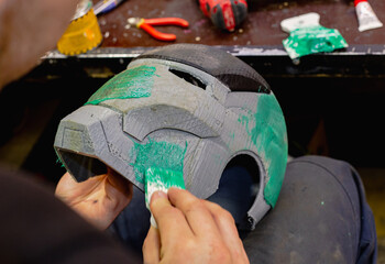 Assembling the iron man mask using polyester resin and putty, handmade. Iron Man mask in the...