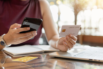 Close up woman hands using smartphone for shopping online payment with credit card