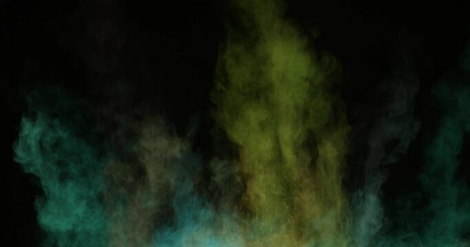 Powder particles explode from the bottom up on a black background. The dust flies in different directions.