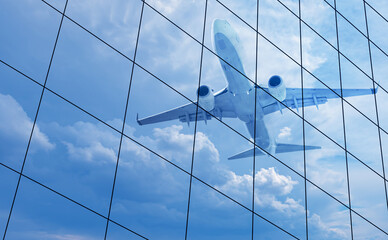 Airplane reflected in skyscraper windows
