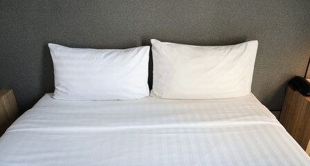 Obraz premium White cushion and white pillow which Modern bedroom interior with a stylish combination of trendy room image