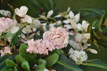 Pink peonies in a basket in the garden