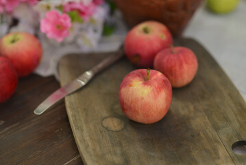 Red apples on wooden board, autumn concept