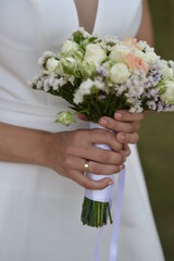 Bride in a wedding dress holding a small bouquet