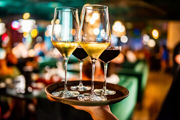 alcohol cocktail and wine set on a waiter tray in bar