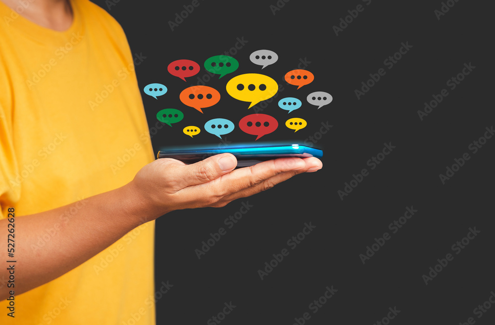 Aufkleber close-up of hand using mobile phone with colorful chat icons on the application
