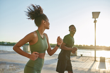 Young smiling black sports couple run or jog